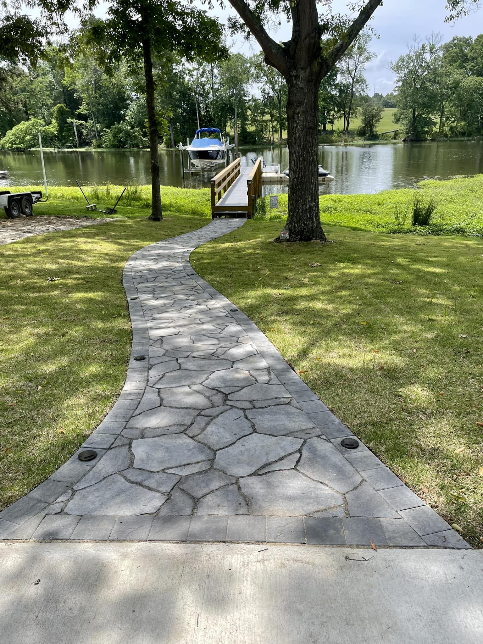 Winding flagstone paver path to lakefront dock in South Carolina