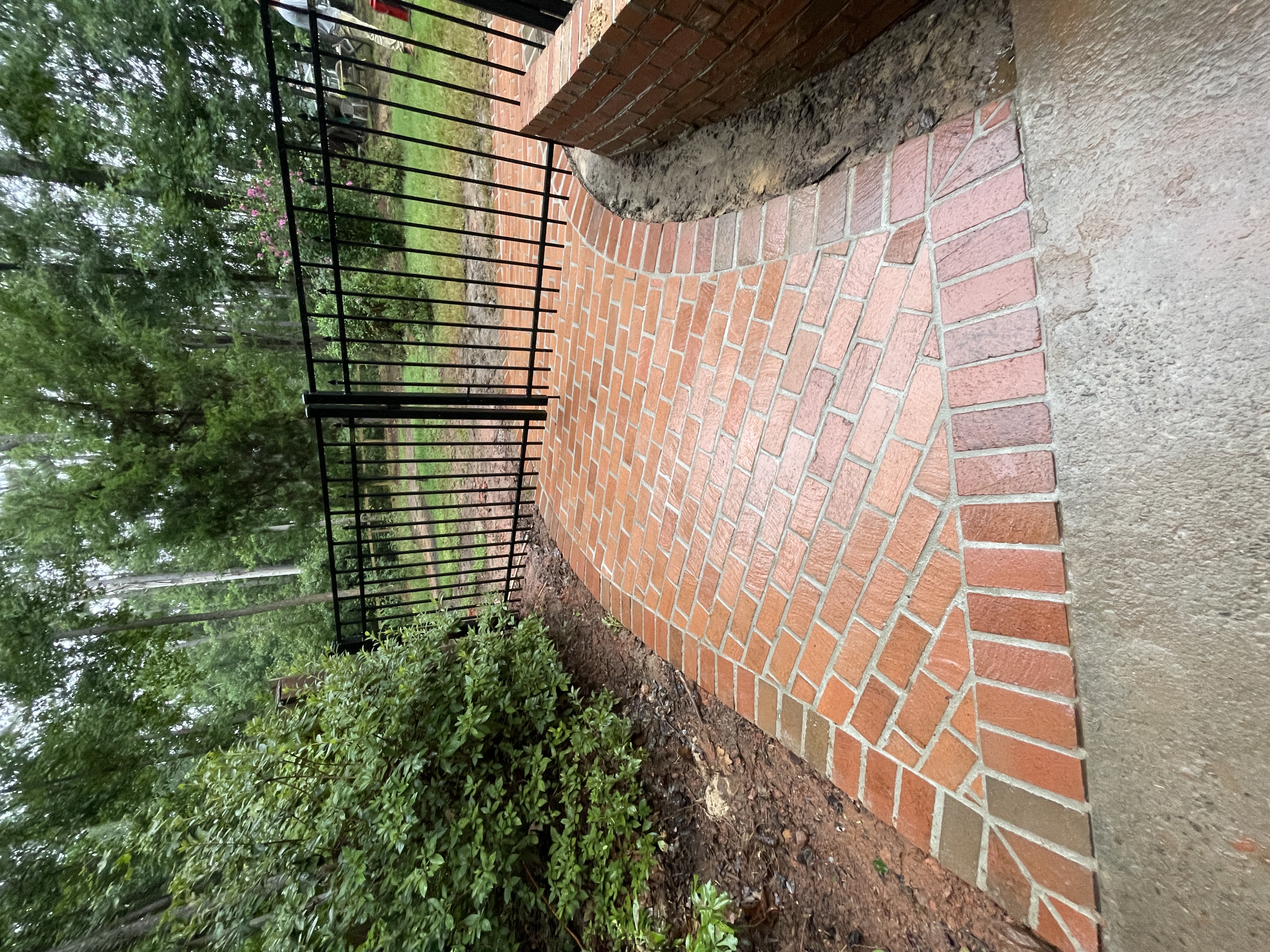 Brick pathway with iron gate by Kalberer Construction