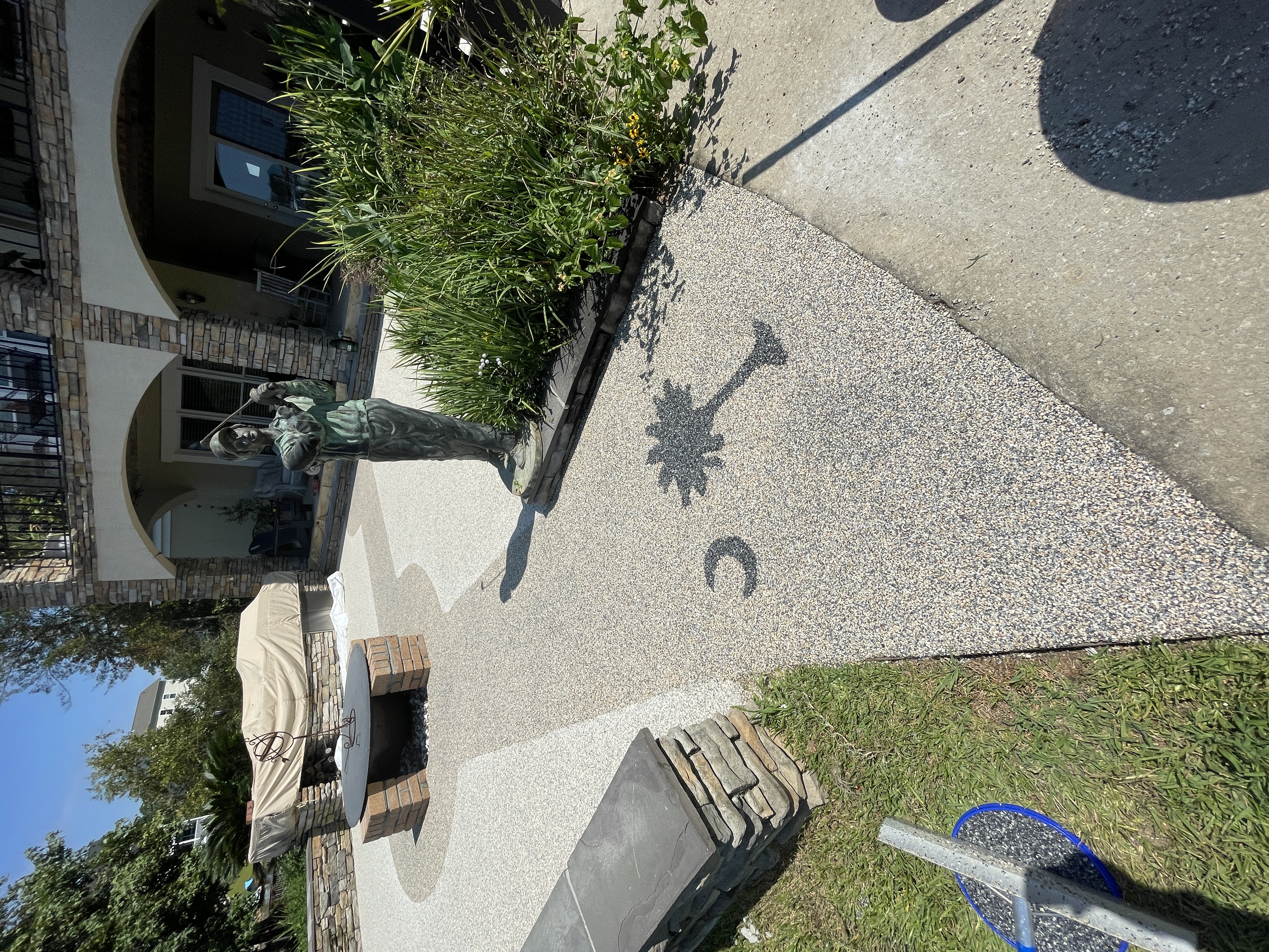 Resin rock patio with palmetto moon inlay and outdoor living area