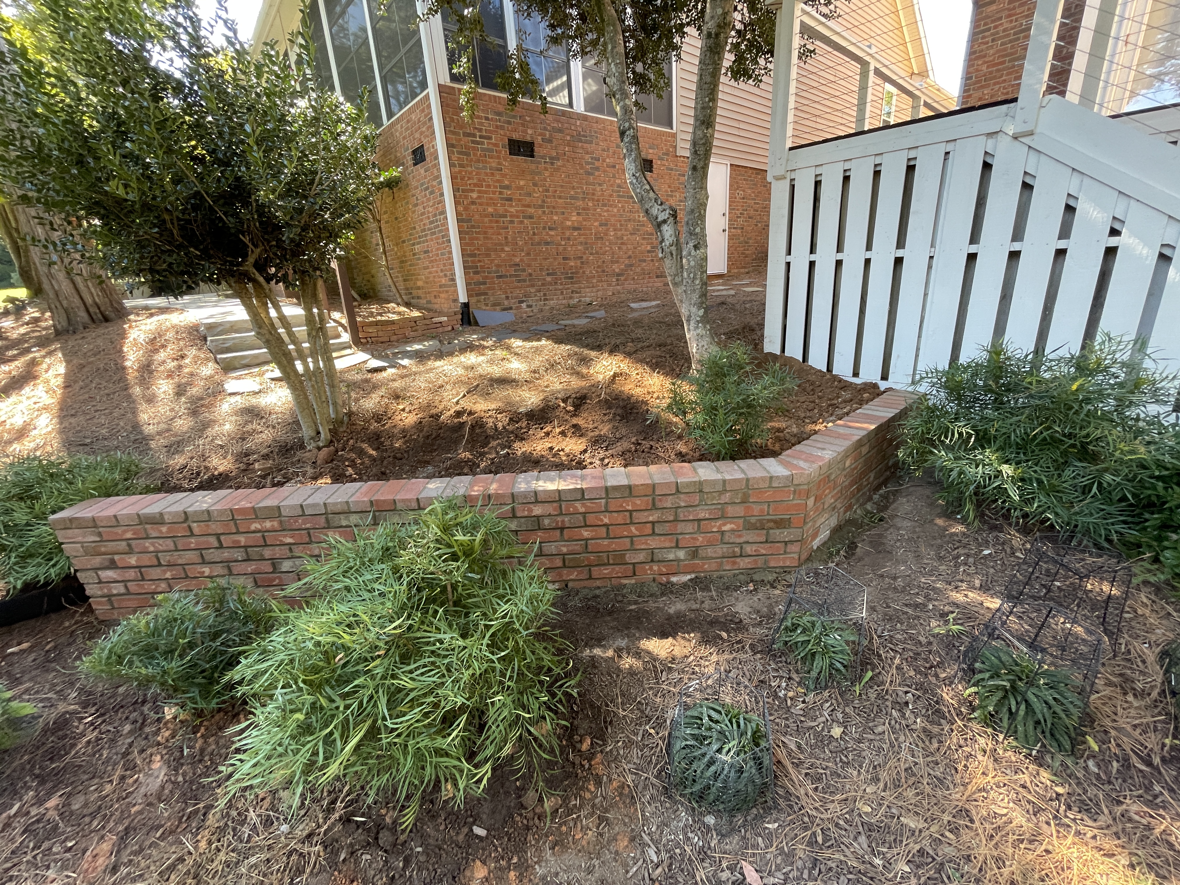 Brick retaining wall and garden border with landscaping