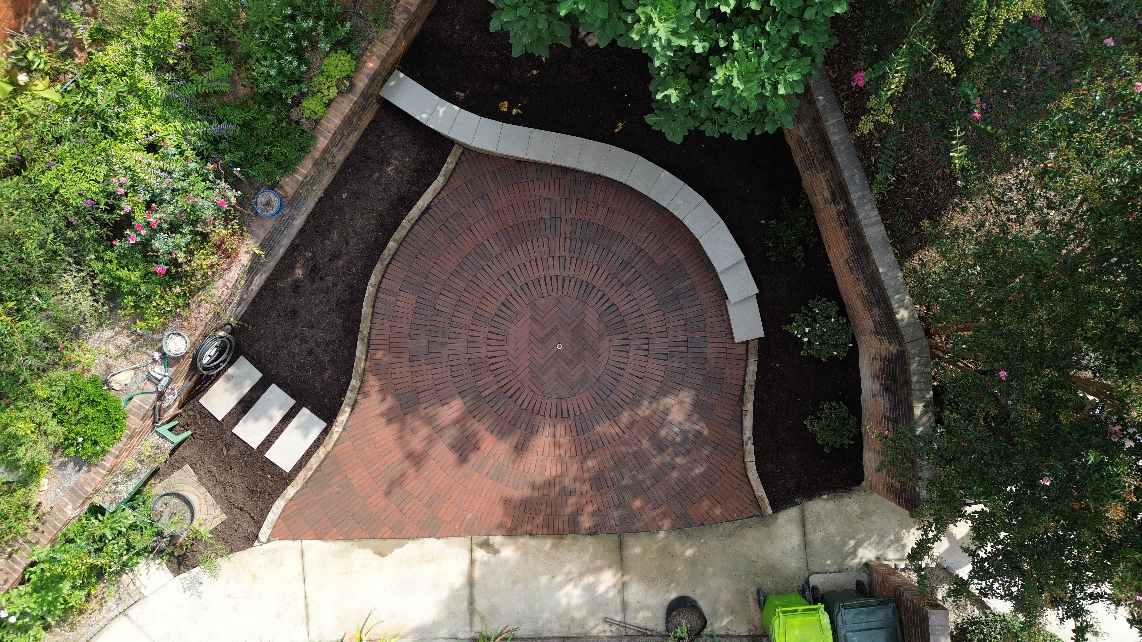 Aerial view of circular brick patio with herringbone pattern