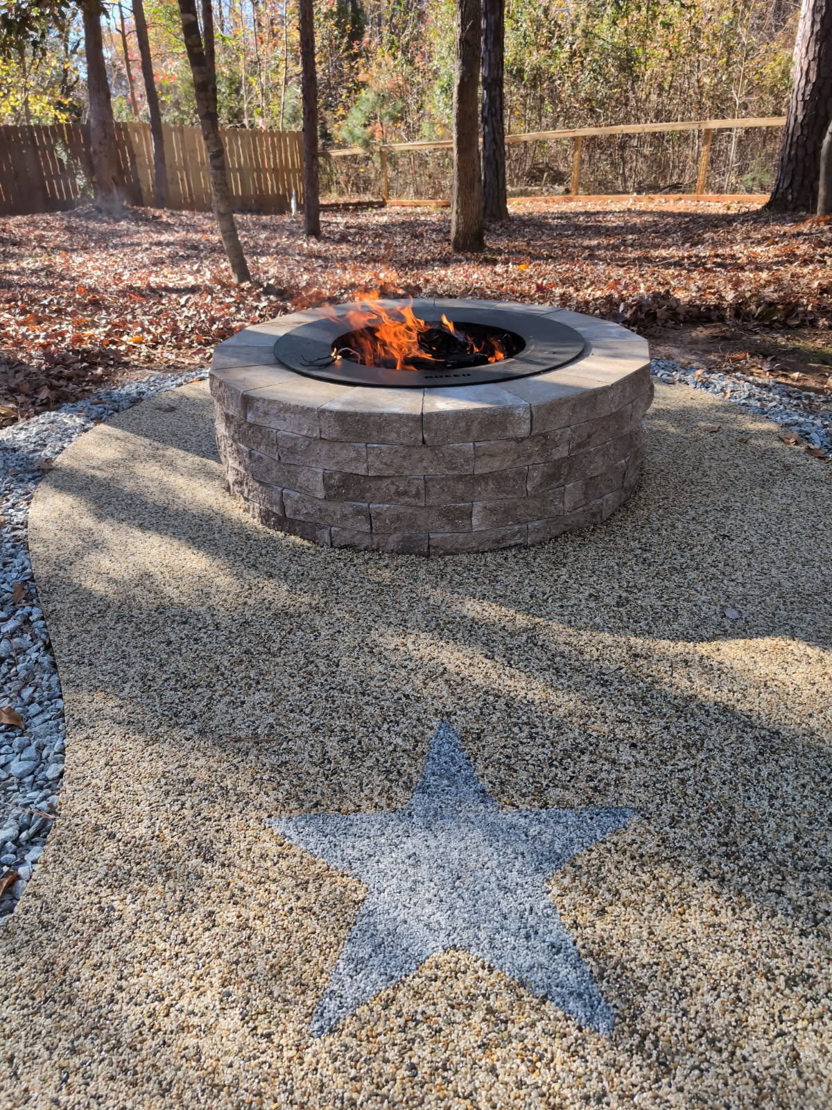 Round stone fire pit with resin rock star patio in South Carolina